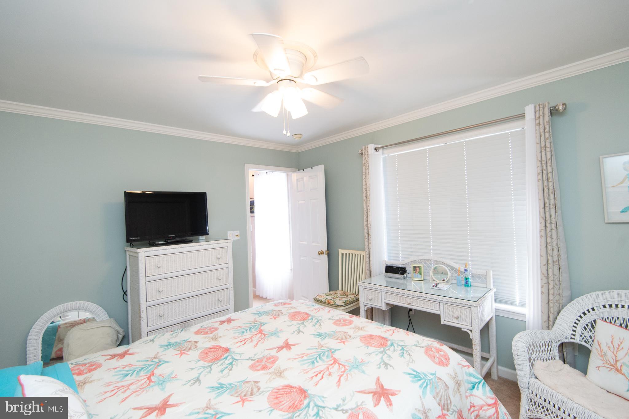 9 Holly Terrace Cambridge, MD 21613 - Photo 38 of 49 a bedroom with a bed and a flat screen tv