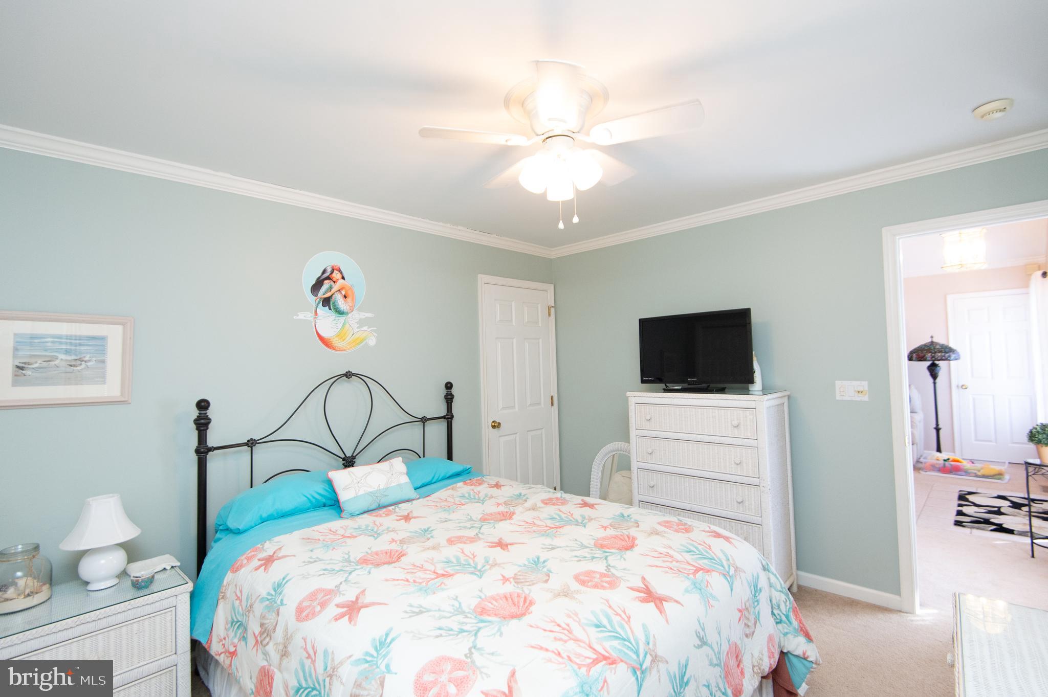 9 Holly Terrace Cambridge, MD 21613 - Photo 39 of 49 a bedroom with a bed and a flat screen tv