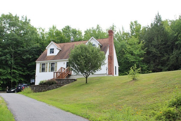 873 Erickson Road Ashby, MA 01431 - Photo 1 of 17 a view of a house with a yard and trees