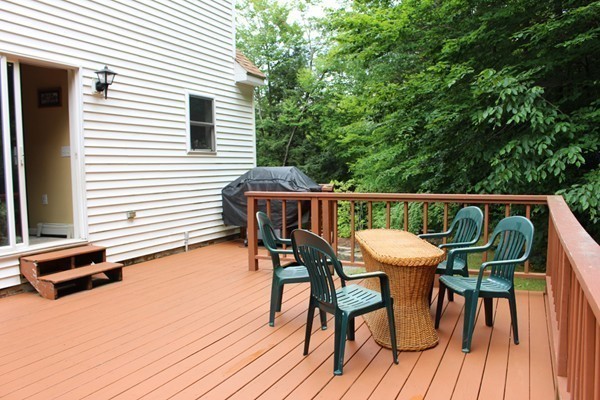 873 Erickson Road Ashby, MA 01431 - Photo 13 of 17 a patio with wooden floor and outdoor seating