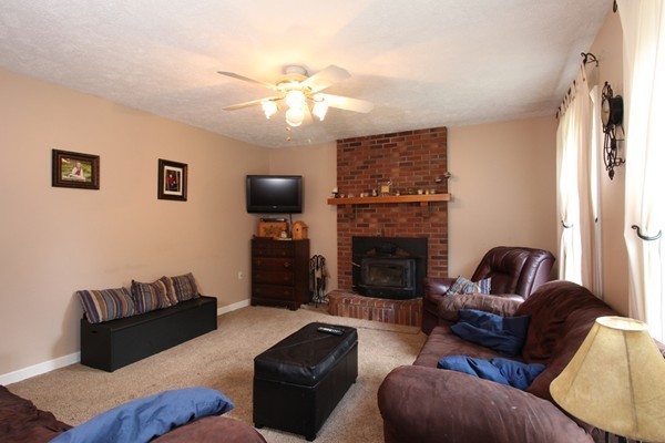 873 Erickson Road Ashby, MA 01431 - Photo 5 of 17 a living room with furniture and a fireplace