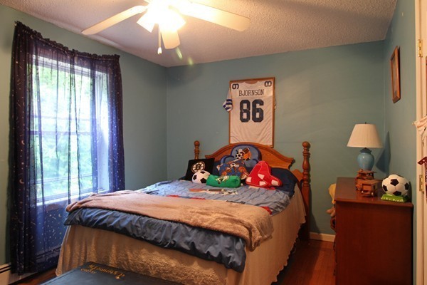 873 Erickson Road Ashby, MA 01431 - Photo 10 of 17 a bedroom with a bed and a chandelier