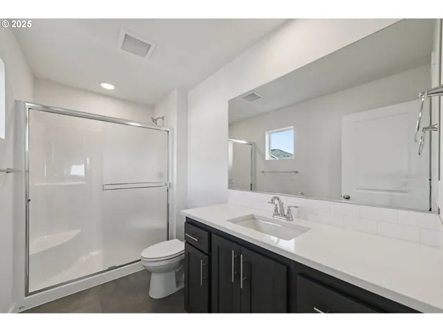 a bathroom with a sink shower and a toilet