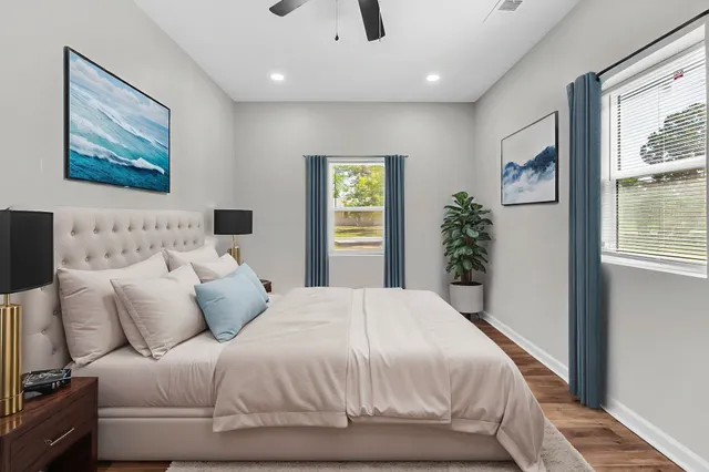 an empty room with fan and windows