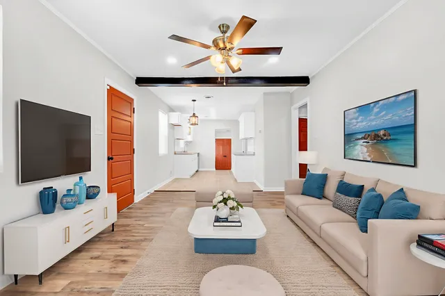 a living room with furniture and a flat screen tv