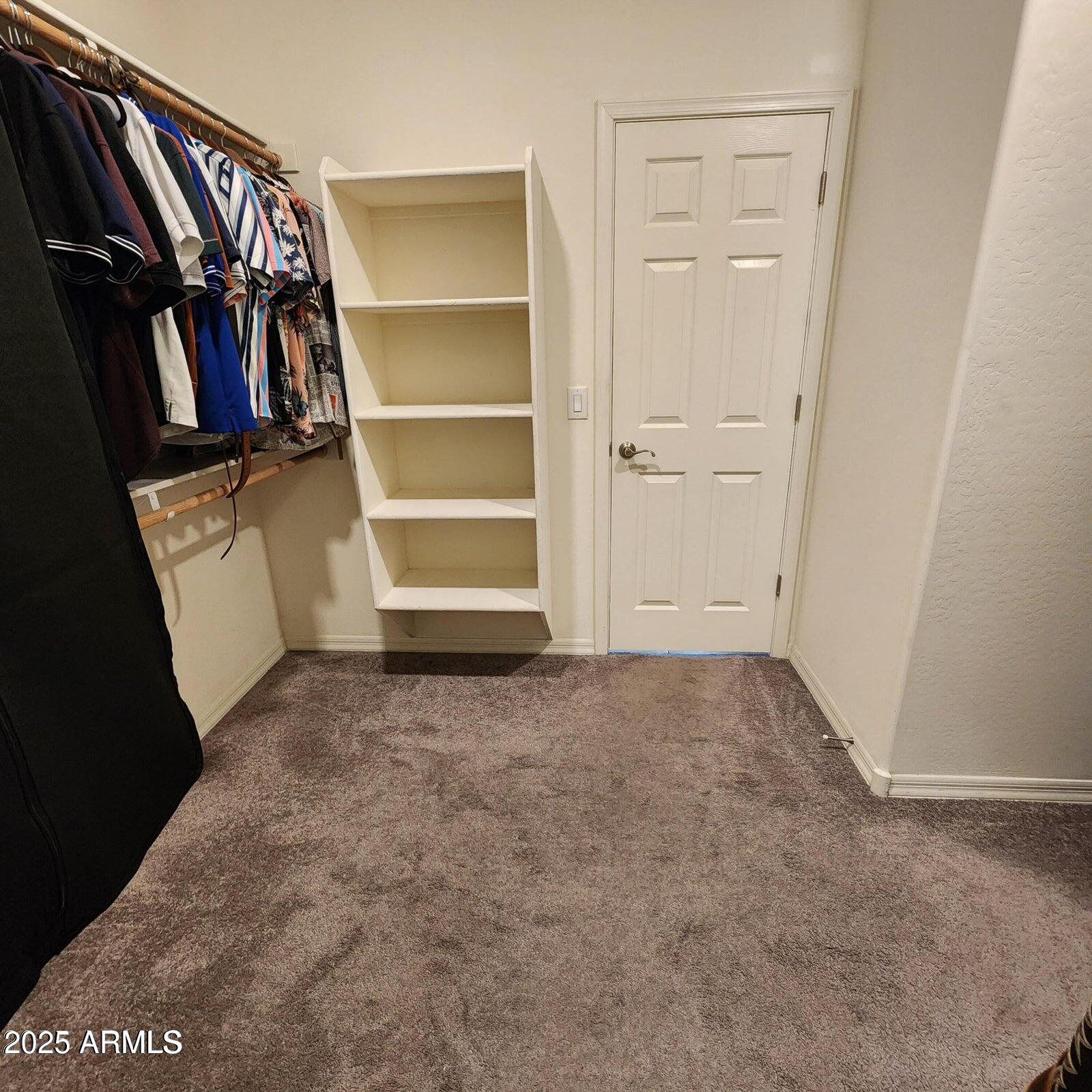 7925 South 24th Way Phoenix, AZ 85042 - Photo 11 of 19 a view of walk in closet with clothes and shoes
