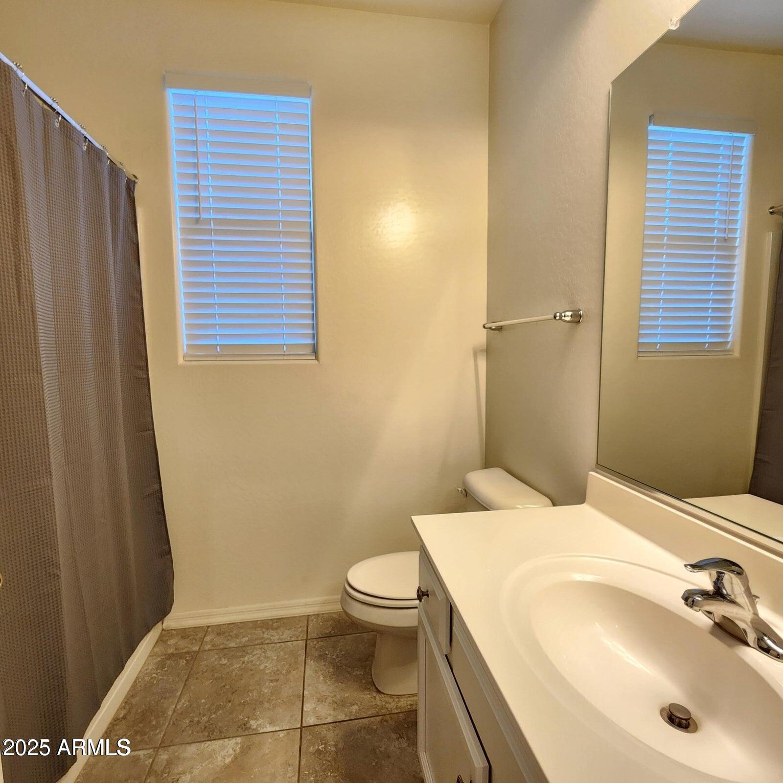 7925 South 24th Way Phoenix, AZ 85042 - Photo 16 of 19 a bathroom with a sink a toilet and shower