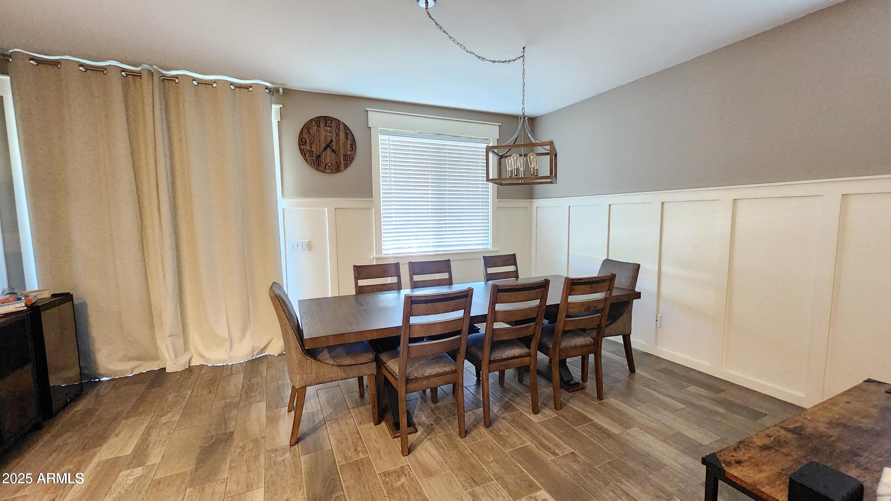 7925 South 24th Way Phoenix, AZ 85042 - Photo 5 of 19 a view of a dining room with furniture and wooden floor