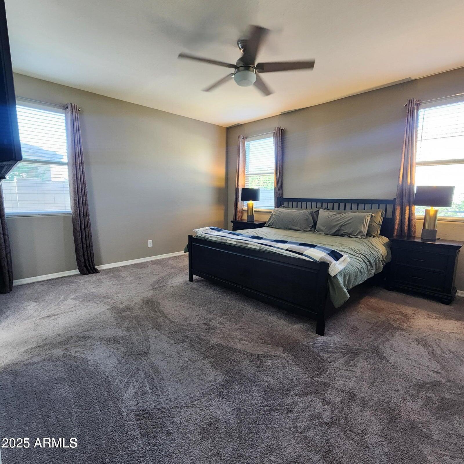 7925 South 24th Way Phoenix, AZ 85042 - Photo 9 of 19 a spacious bedroom with a bed and window