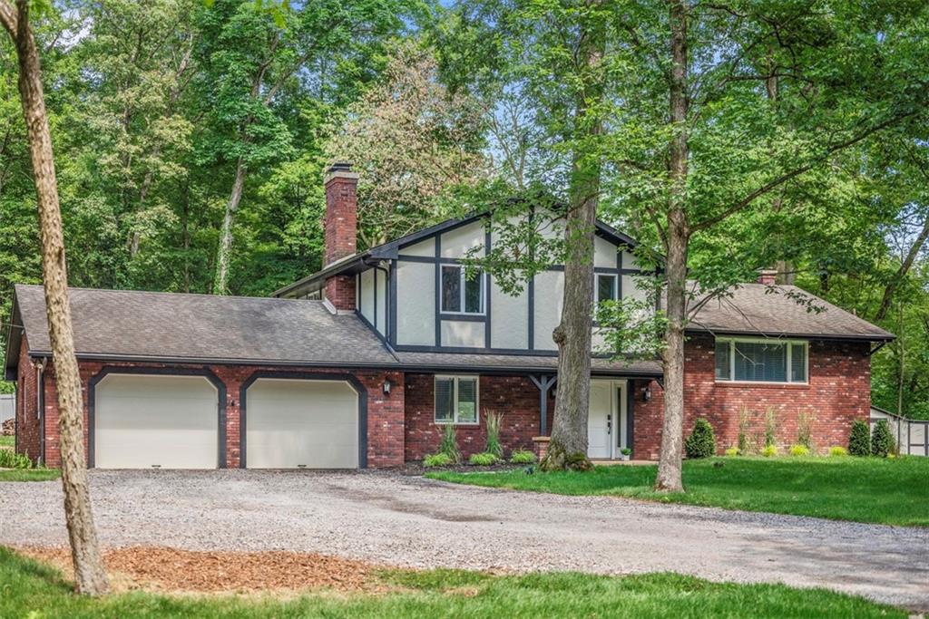 a front view of a house with a garden and plants