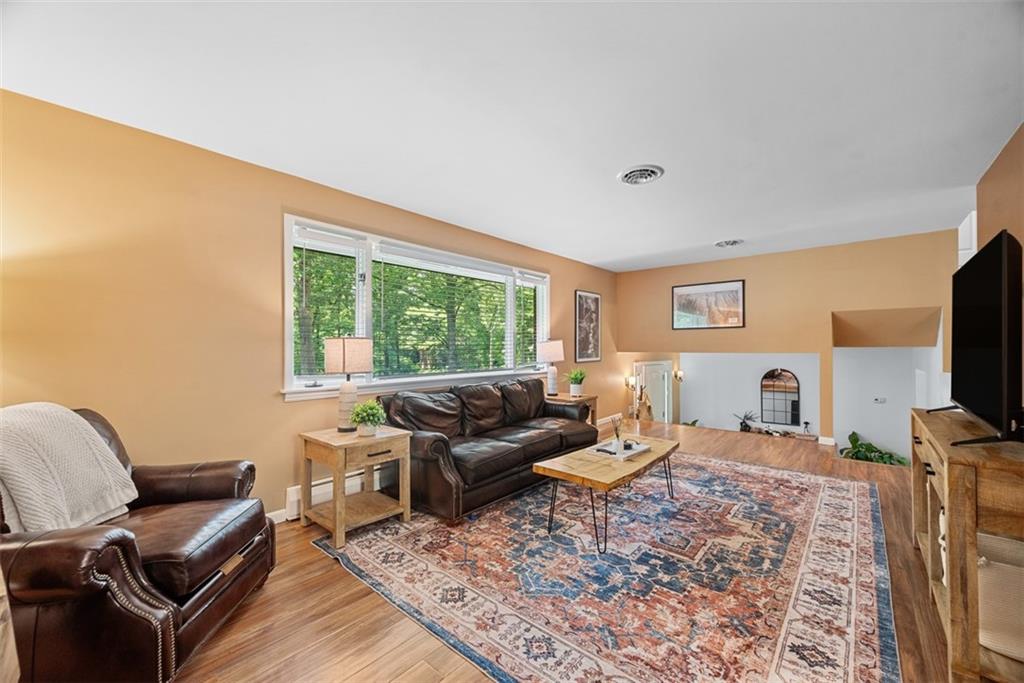 124 Heath Drive Baden, PA 15005 - Photo 12 of 42 a living room with furniture a flat screen tv and a window