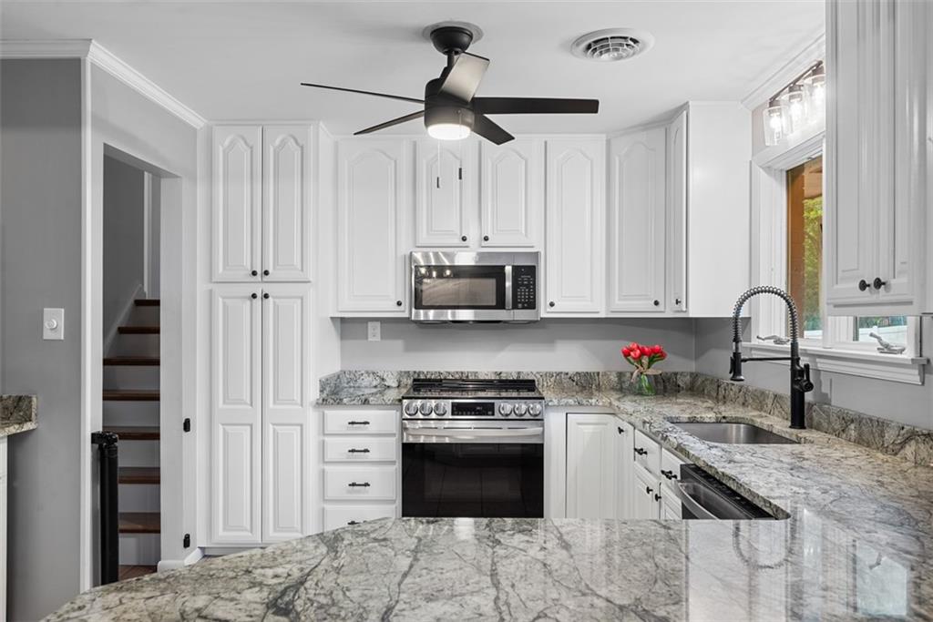124 Heath Drive Baden, PA 15005 - Photo 14 of 42 a kitchen with stainless steel appliances granite countertop a stove sink and cabinets