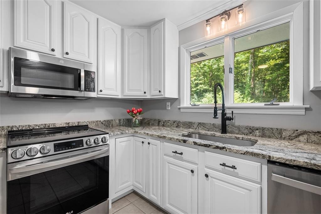 124 Heath Drive Baden, PA 15005 - Photo 17 of 42 a kitchen with granite countertop cabinets stainless steel appliances a sink and window