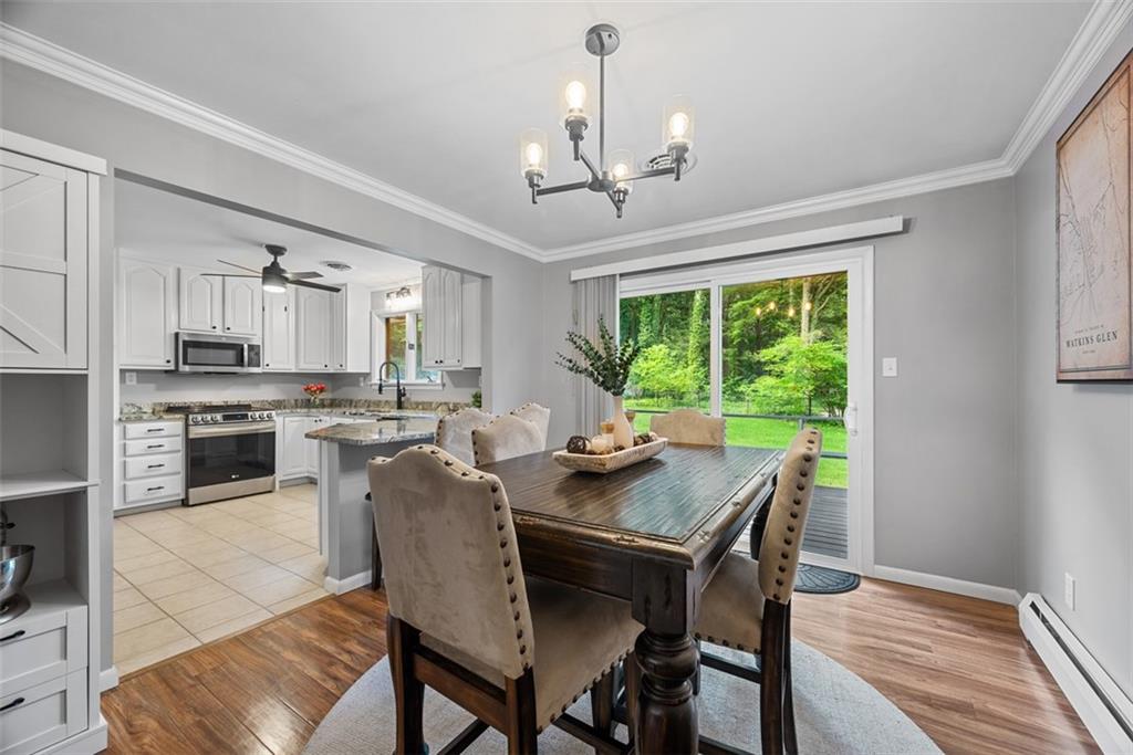 124 Heath Drive Baden, PA 15005 - Photo 19 of 42 a view of a dining room with furniture window and wooden floor