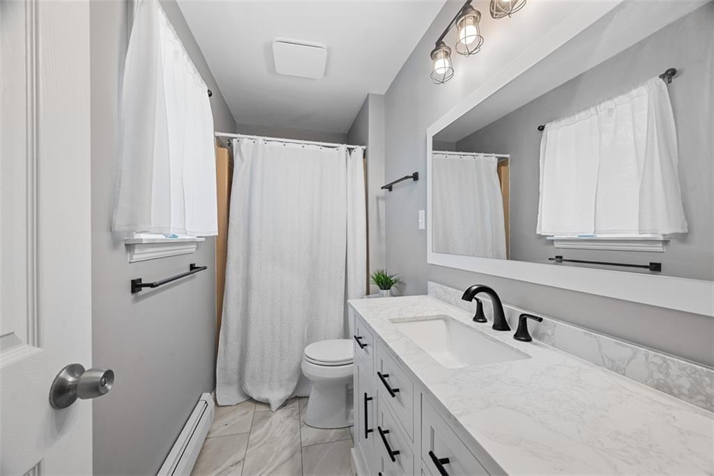 124 Heath Drive Baden, PA 15005 - Photo 24 of 42 a bathroom with a granite countertop sink mirror vanity and toilet