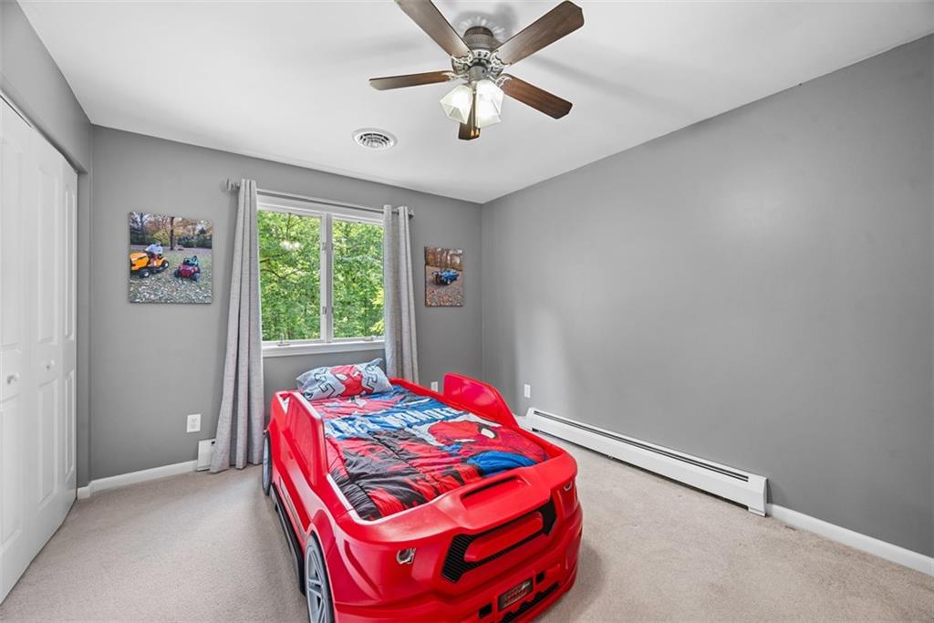 124 Heath Drive Baden, PA 15005 - Photo 27 of 42 a bedroom with a bed and a chandelier