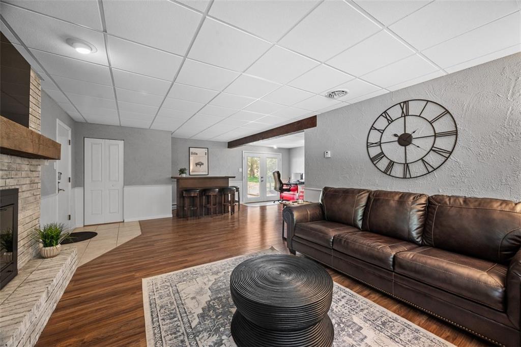 124 Heath Drive Baden, PA 15005 - Photo 28 of 42 a living room with furniture a fireplace and a table