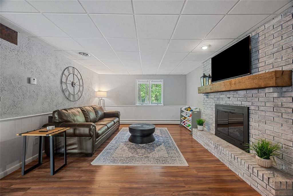 124 Heath Drive Baden, PA 15005 - Photo 30 of 42 a living room with furniture a flat screen tv and a fireplace