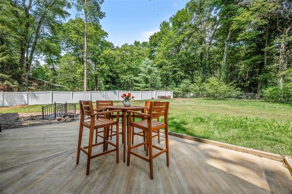 124 Heath Drive Baden, PA 15005 - Photo 34 of 42 a view of a backyard with table and chairs with wooden floor and fence