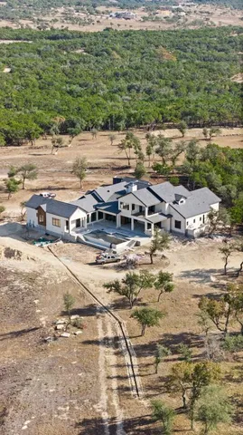 a view of a house with swimming pool and sitting area