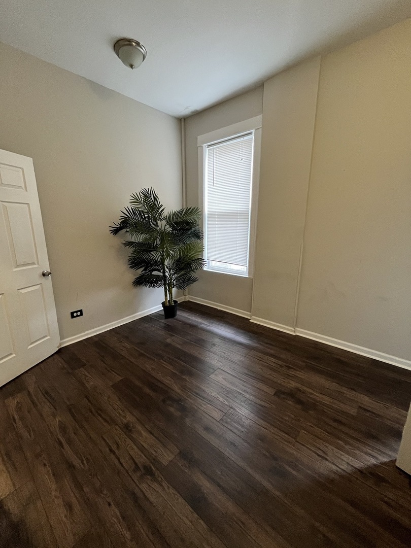 847 East 65th Street, Unit 2 Chicago, IL 60637 - Photo 12 of 13 a view of a room with wooden floor and bench