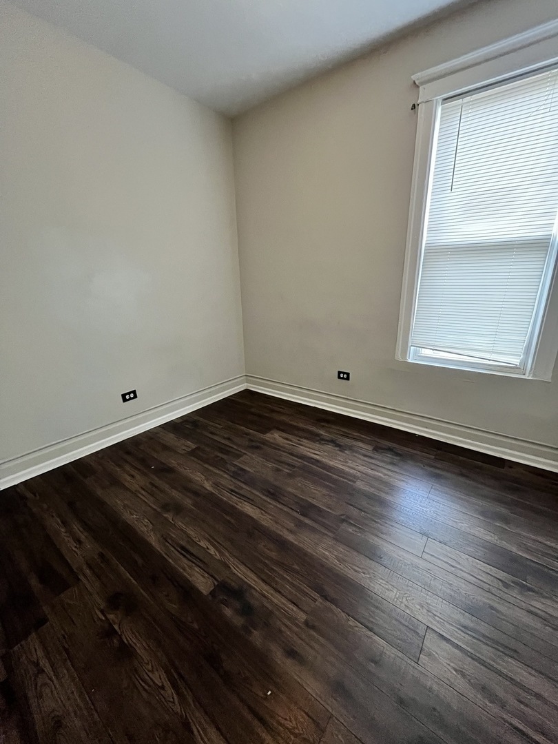 847 East 65th Street, Unit 2 Chicago, IL 60637 - Photo 13 of 13 a view of empty room with wooden floor and fan