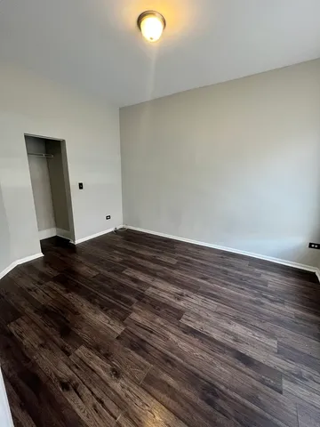 a view of room with wooden floor