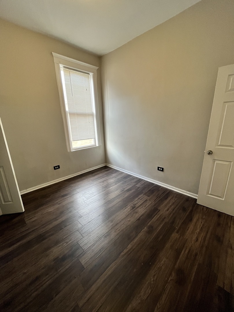 847 East 65th Street, Unit 2 Chicago, IL 60637 - Photo 8 of 13 a view of room with hardwood floor and window