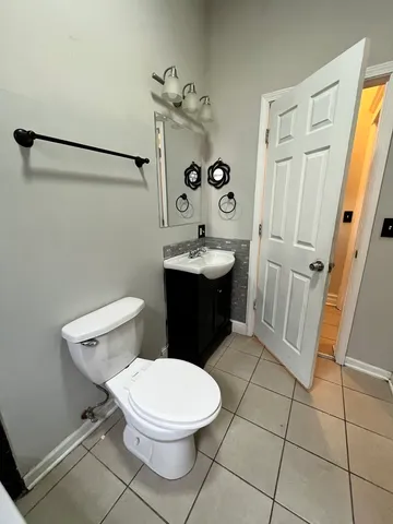 a bathroom with a sink a toilet a mirror and shower