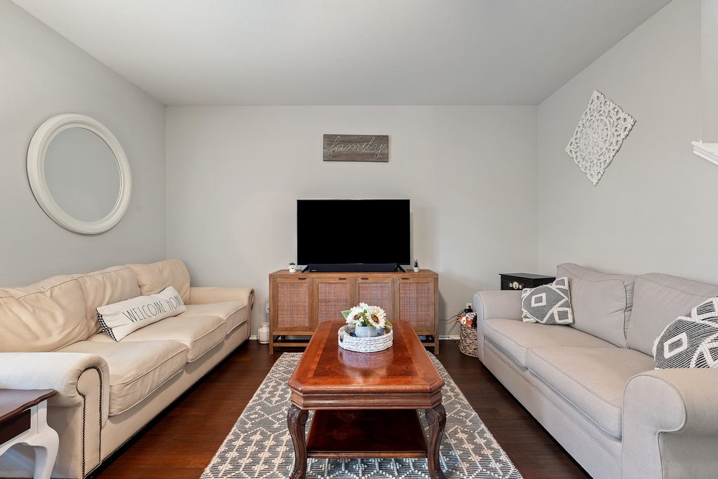 140 Wolfberry Path Buda, TX 78610 - Photo 7 of 35 a living room with furniture a flat screen tv and a couch