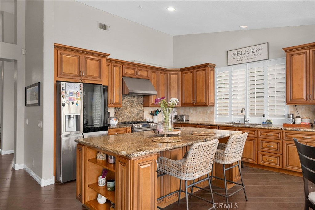 14113 Los Robles Court Rancho Cucamonga, CA 91739 - Photo 13 of 33 a kitchen with granite countertop a sink stove and cabinets