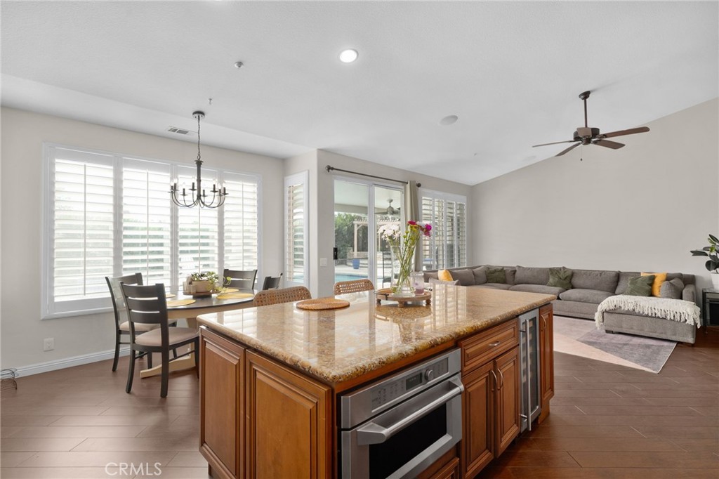 14113 Los Robles Court Rancho Cucamonga, CA 91739 - Photo 16 of 33 a open kitchen with stainless steel appliances granite countertop a sink and chairs
