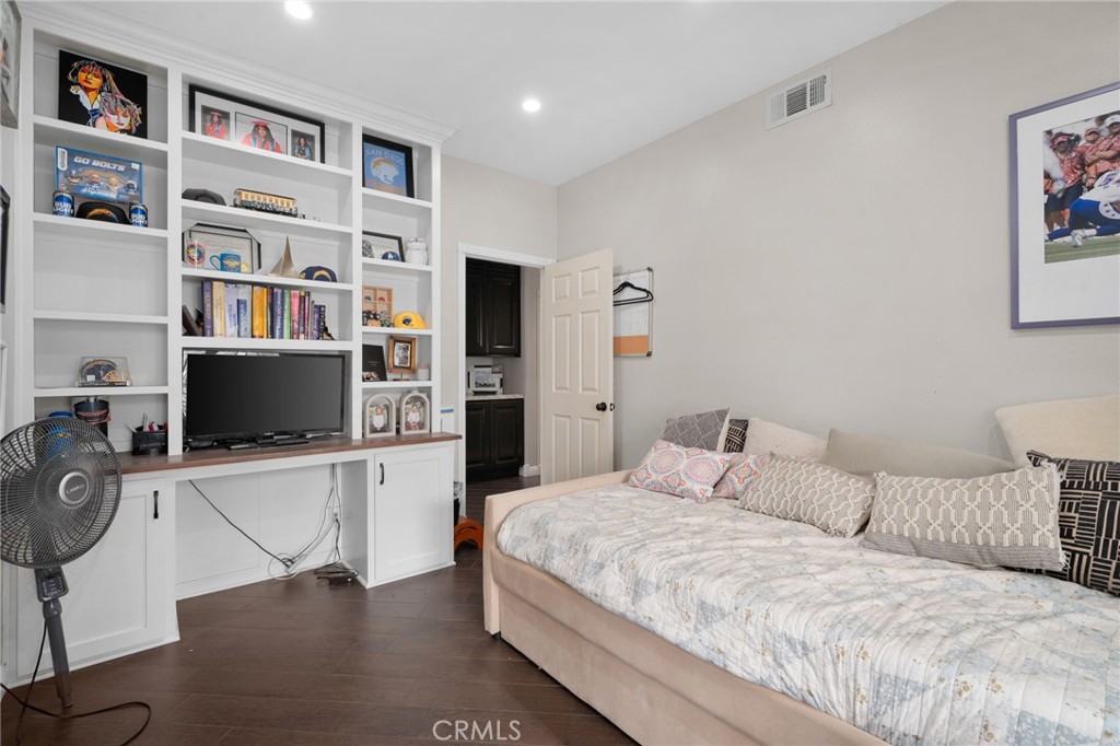 14113 Los Robles Court Rancho Cucamonga, CA 91739 - Photo 18 of 33 a bedroom with a bed cabinets and book shelf
