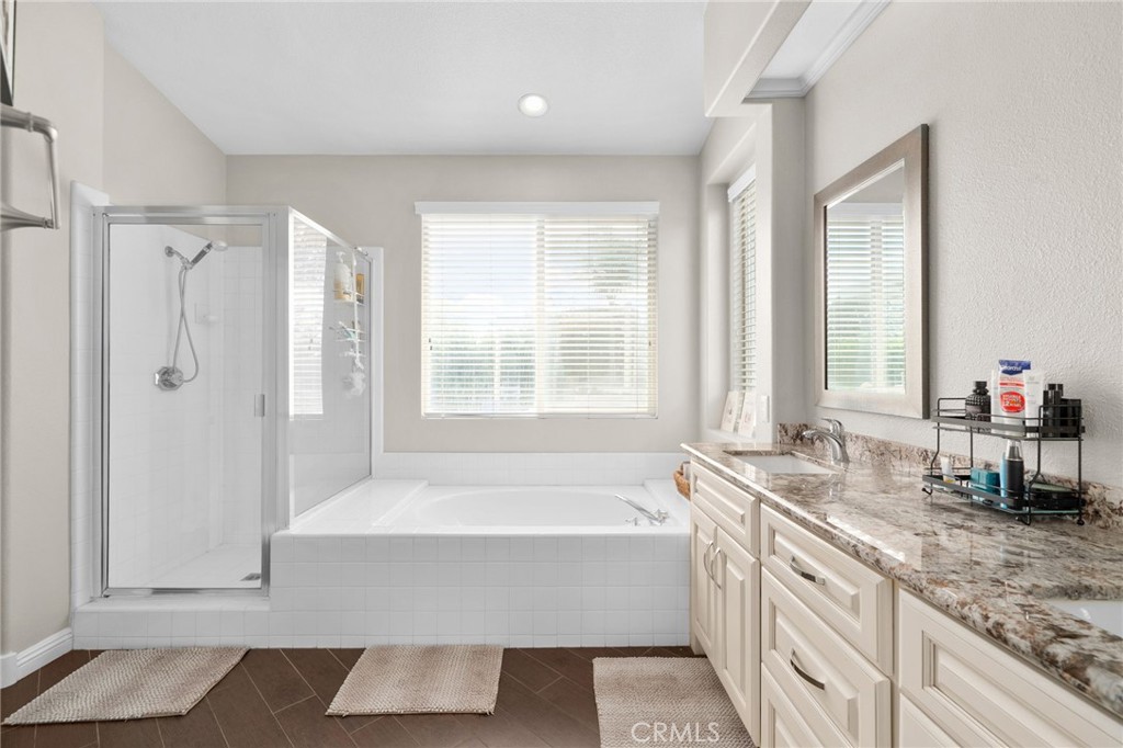 14113 Los Robles Court Rancho Cucamonga, CA 91739 - Photo 23 of 33 a bathroom with a tub a sink and a window