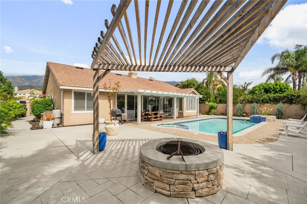 14113 Los Robles Court Rancho Cucamonga, CA 91739 - Photo 33 of 33 a view of a house with floor to ceiling windows and palm tree