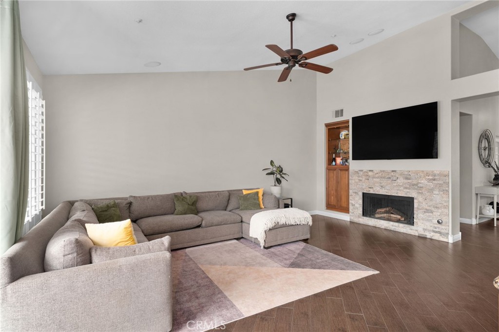 14113 Los Robles Court Rancho Cucamonga, CA 91739 - Photo 10 of 33 a living room with furniture a fireplace and a flat screen tv