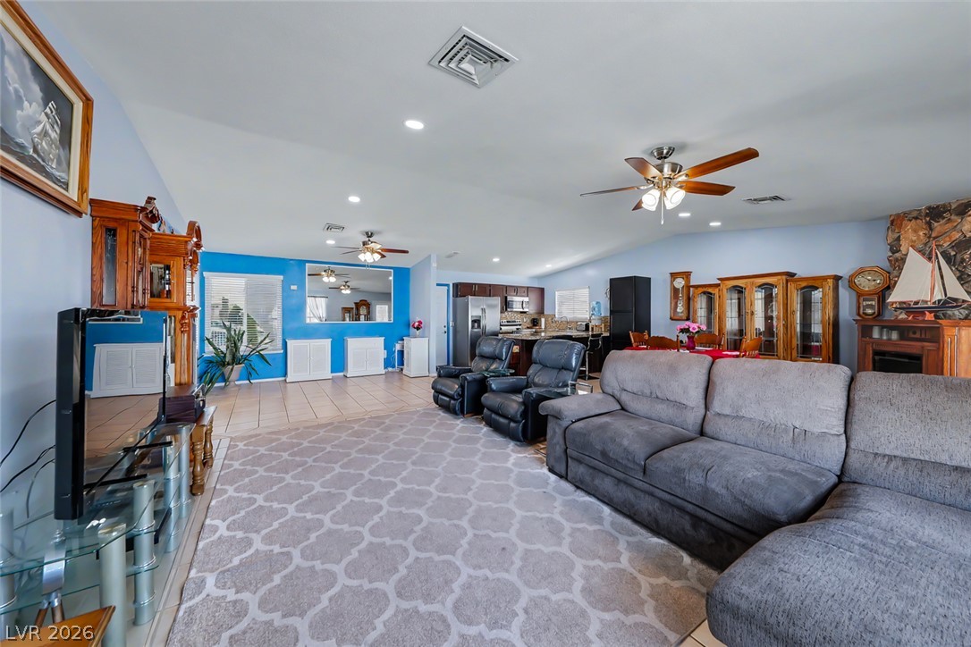 3107 Trueno Road Henderson, NV 89014 - Photo 21 of 37 A spacious living area flows seamlessly into the kitchen, creating an inviting open-concept design.