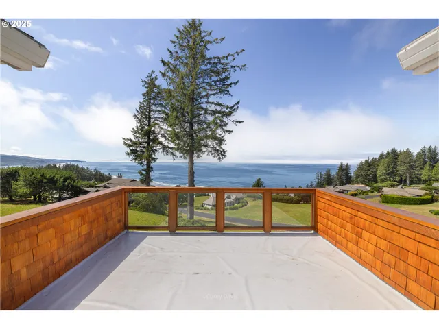 a view of swimming pool with outdoor seating and lake view