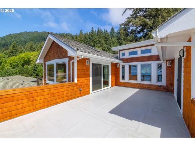 a open kitchen with granite countertop a stove top oven a sink and a wooden floor