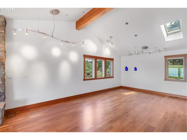 a kitchen with stainless steel appliances granite countertop a refrigerator a stove and a wooden floors