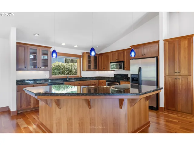 a kitchen with granite countertop a sink and cabinets