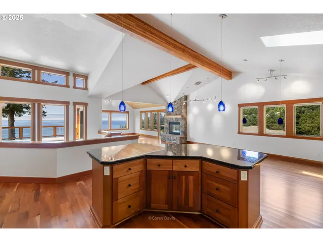 a kitchen with stainless steel appliances granite countertop a stove and a wooden floors