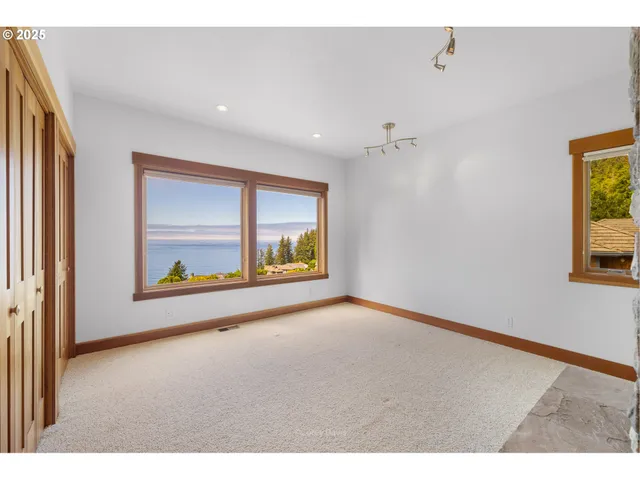 a bathroom with a granite countertop sink a toilet a mirror and shower