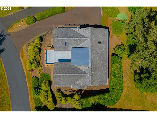 an aerial view of residential house with outdoor space and swimming pool