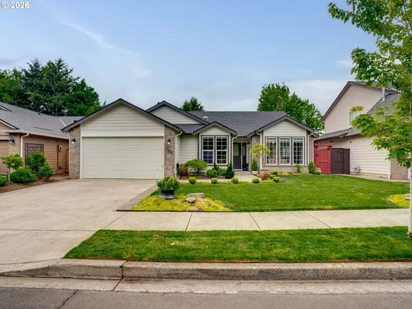 a front view of a house with a garden
