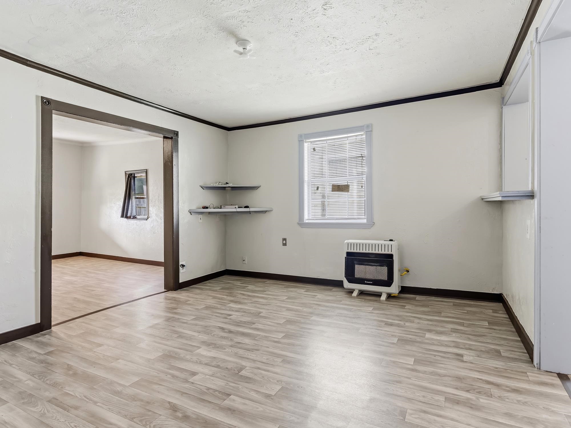 737 9th Street Port Arthur, TX 77640 - Photo 7 of 20 a view of a big room with wooden floor and a window