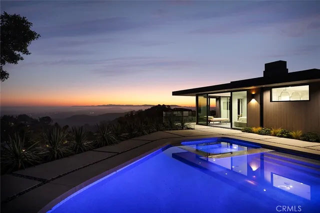 a swimming pool with outdoor seating and yard