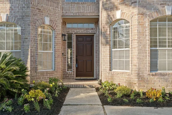 a view of a hallway with windows and stairs