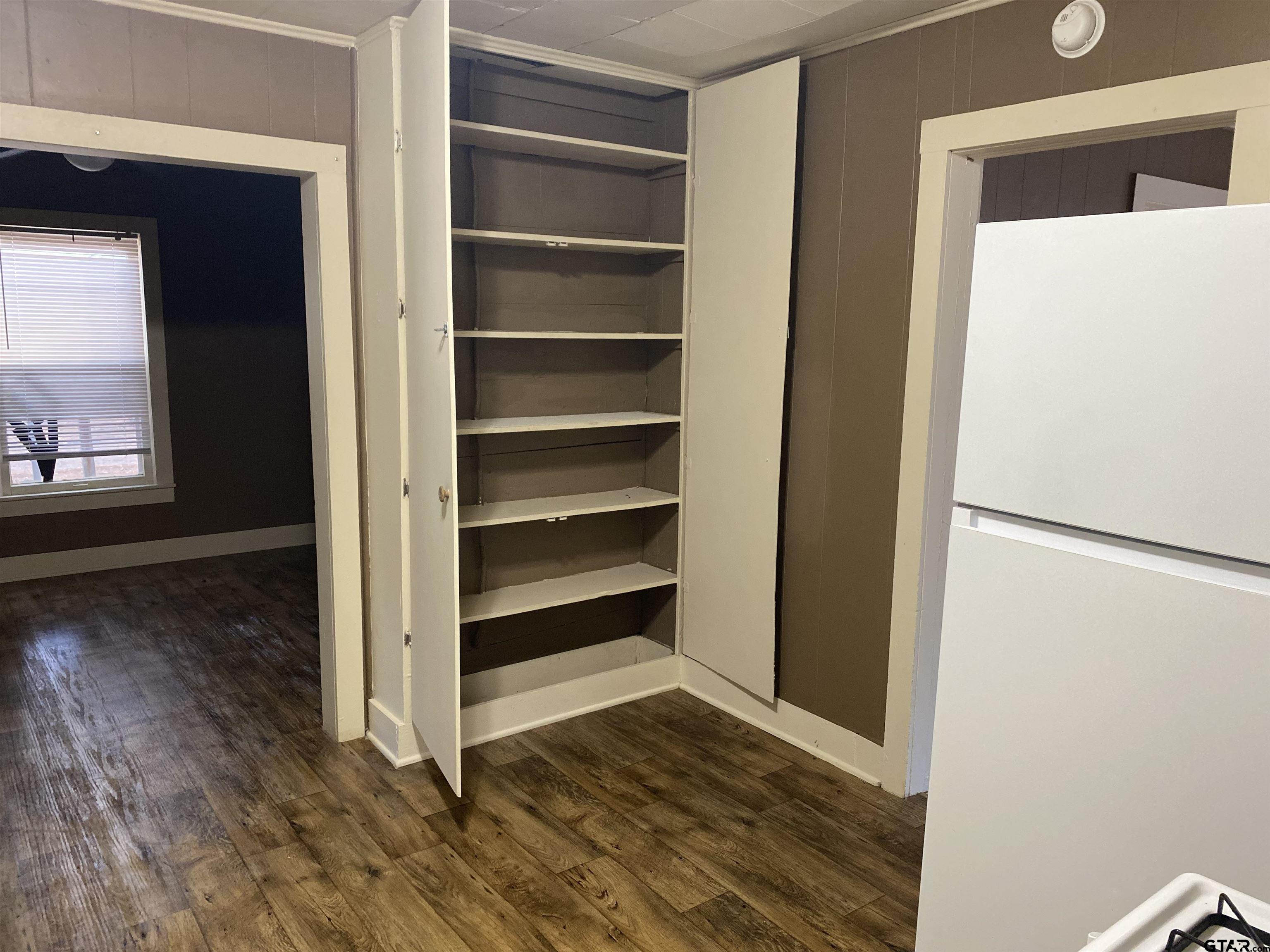 502 3rd Street Quitman, TX 75783 - Photo 12 of 22 a view of walk in closet with empty racks