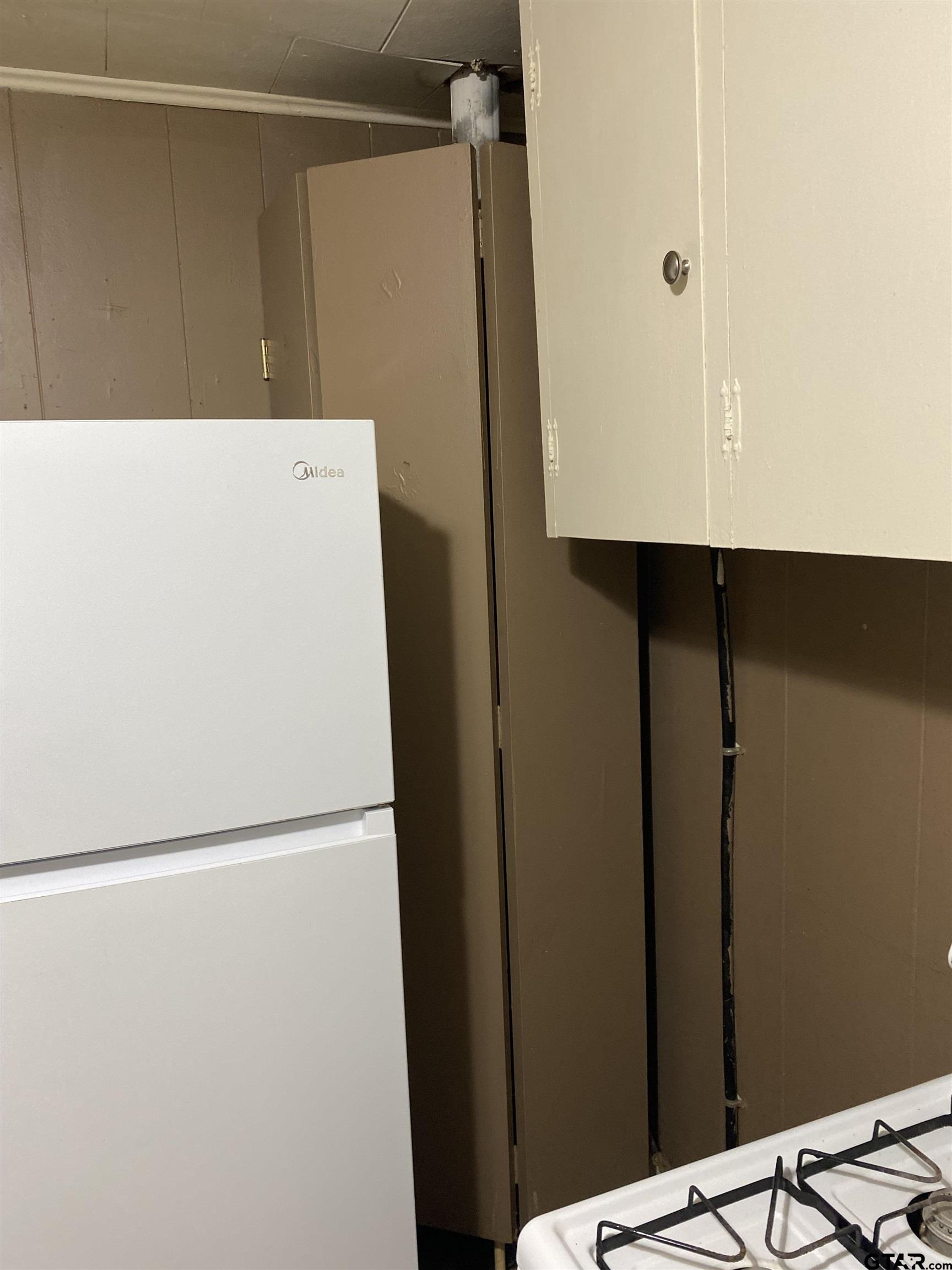 502 3rd Street Quitman, TX 75783 - Photo 13 of 22 a white refrigerator freezer sitting inside of a kitchen